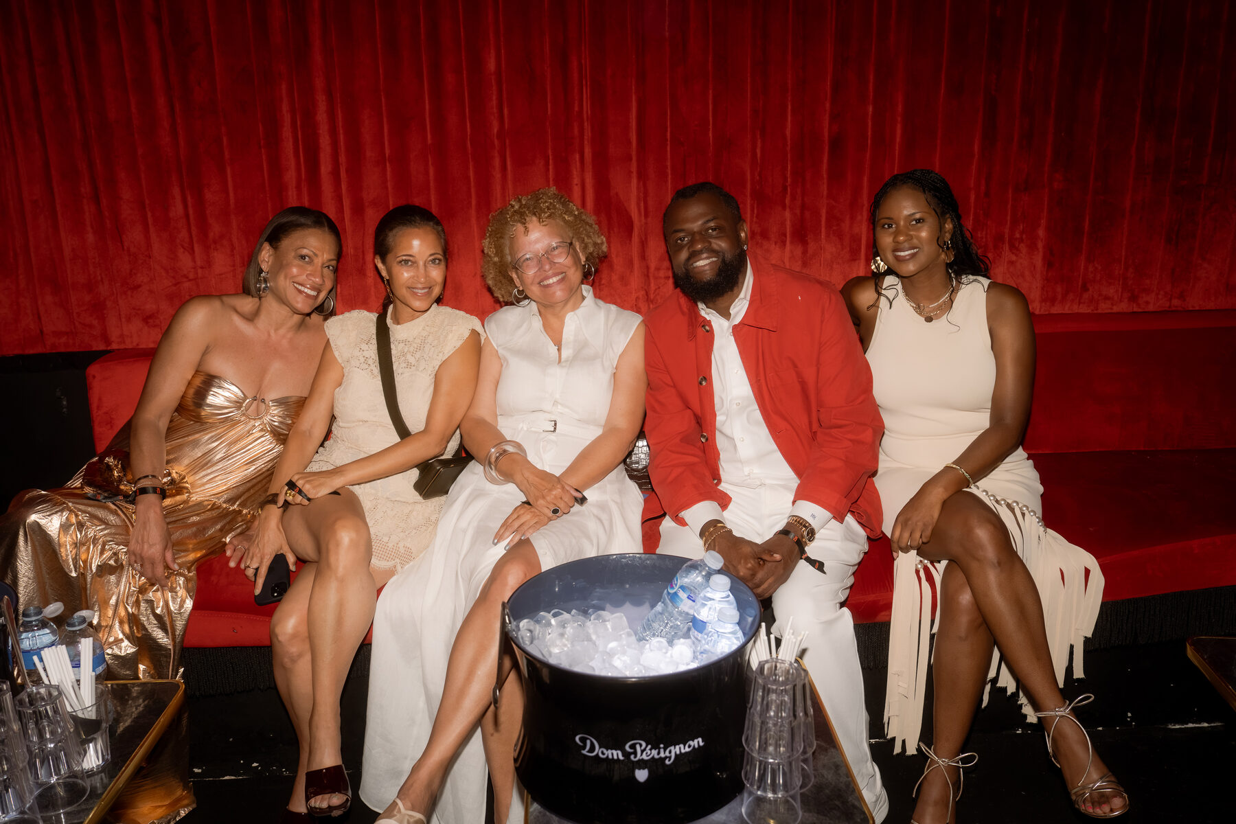 Guests gathered on a couch with champagne