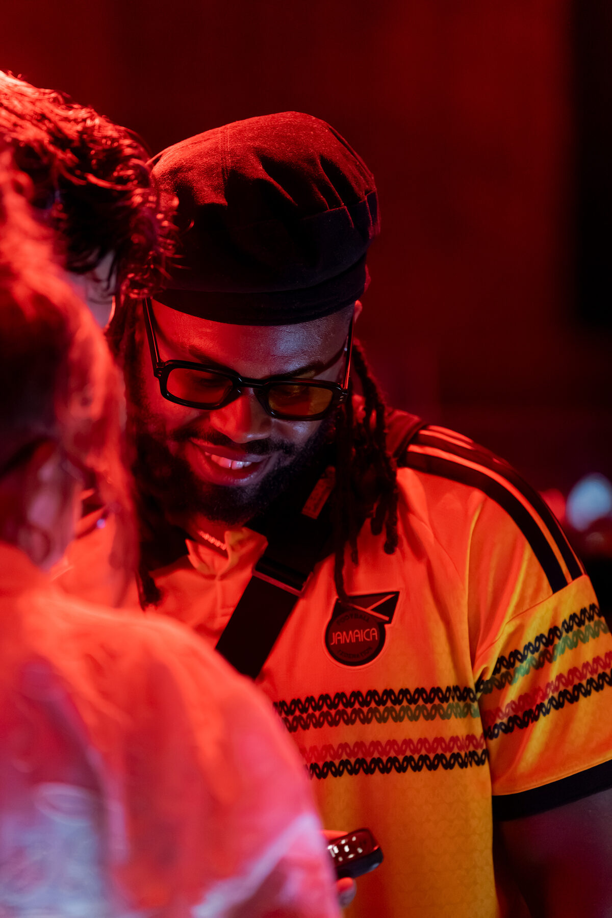 Guest in a yellow jersey lit by red smoke