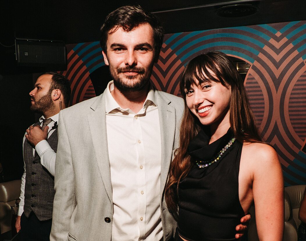 Group of guests smiling together at the after-party